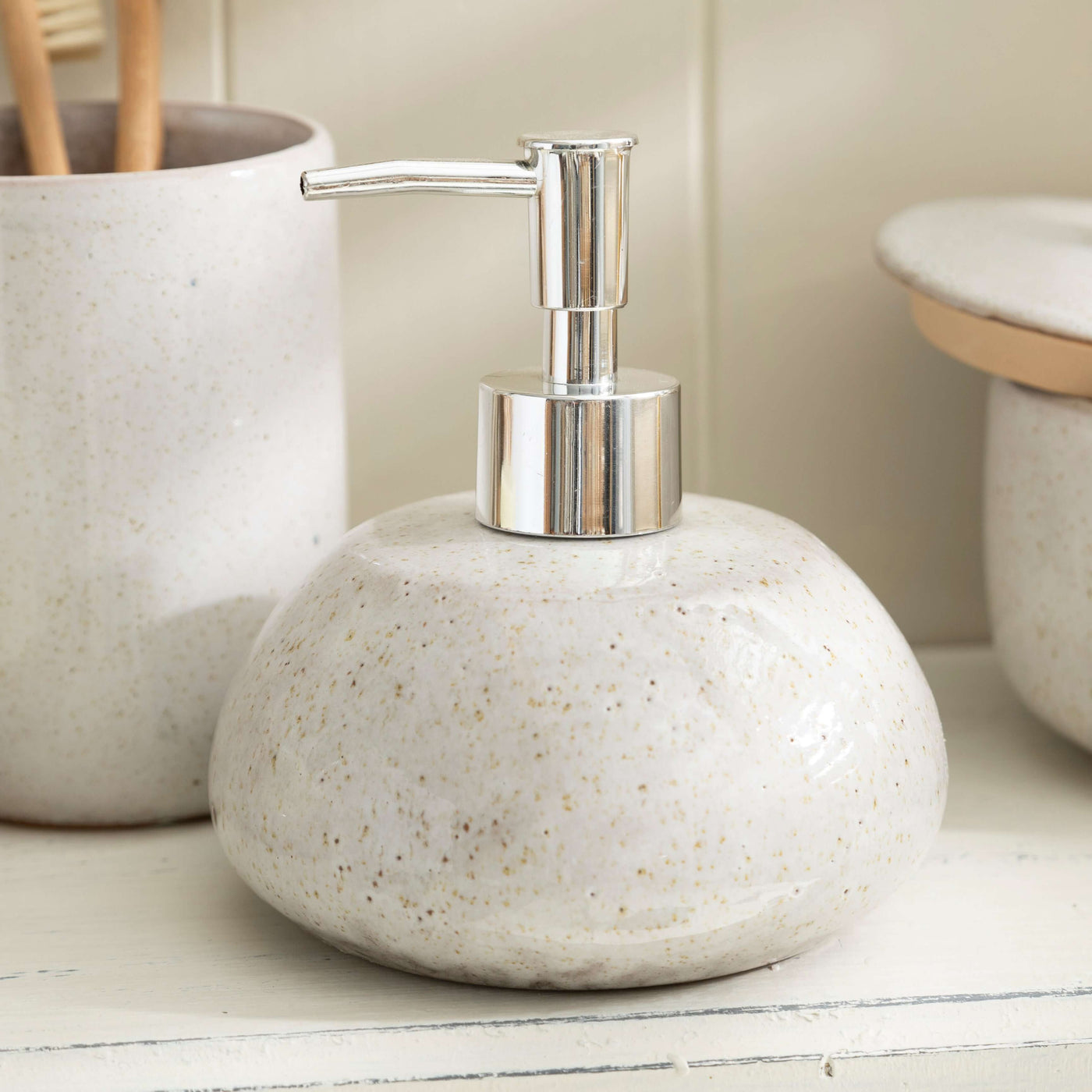 Stone effect ceramic lotion dispenser from bathroom accessory set with subtle texture, perfect for adding natural elegance.