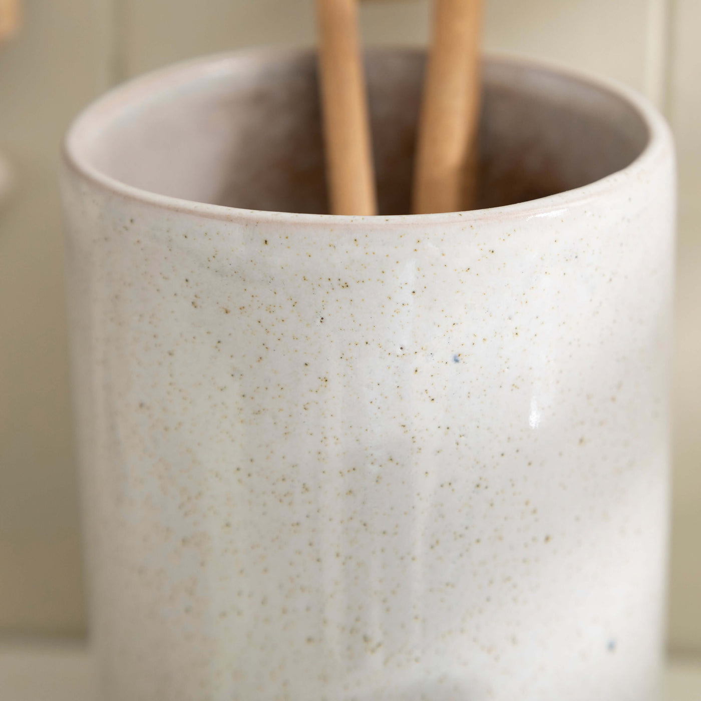Stone effect ceramic toothbrush holder with a subtle textured finish, part of a stylish bathroom accessory set.