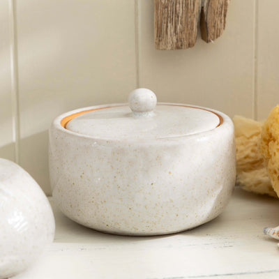 Stone effect ceramic lidded jar from bathroom accessory set on white surface, showcasing elegant and natural design.